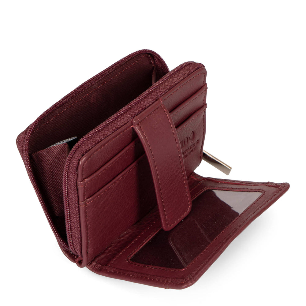 Interior view of a burgundy card holder called basics by tracker, showing its 2 front card slots, zipper, interior coin pocket, ID window, and closure strap.