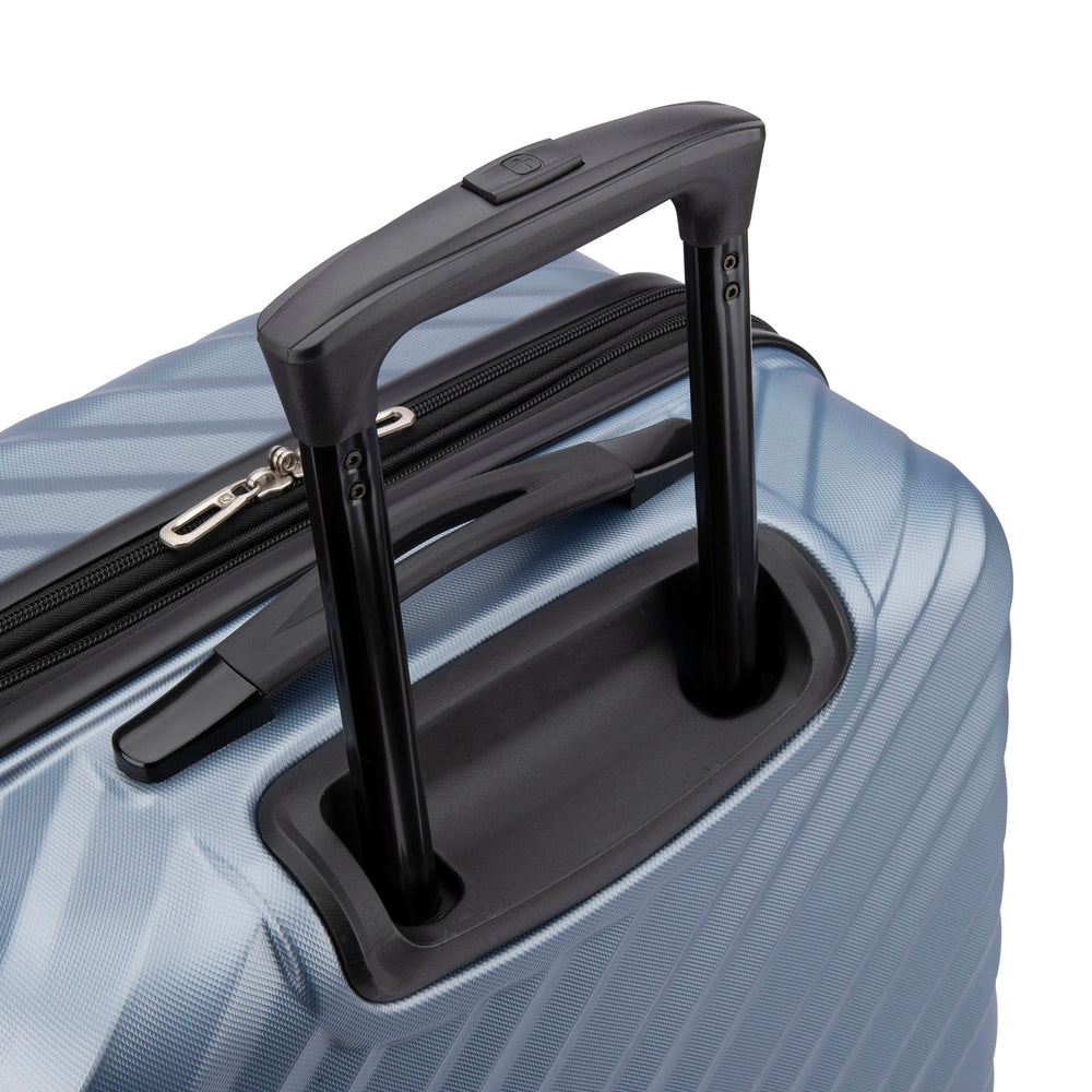 Close side view of a silver hard side luggage called MOD designed by Swiss Gear sold at Bentley, showcasing its telescopic handle.